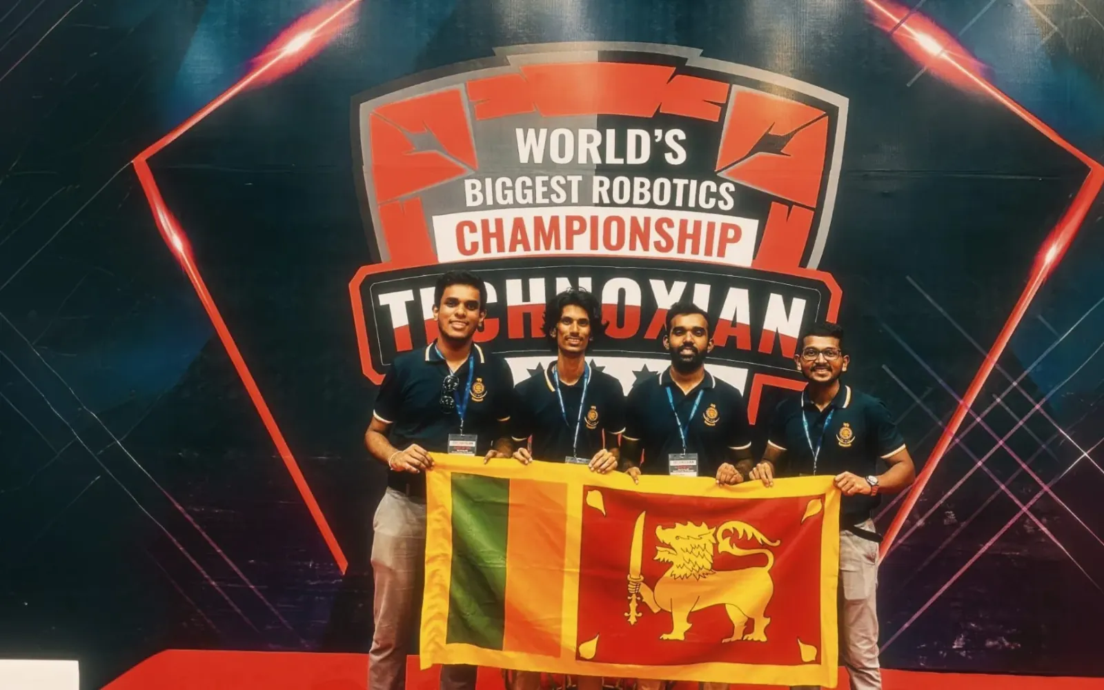 RoboticGen engineers holding the Sri Lankan flag at the Technoxian robotics championship.